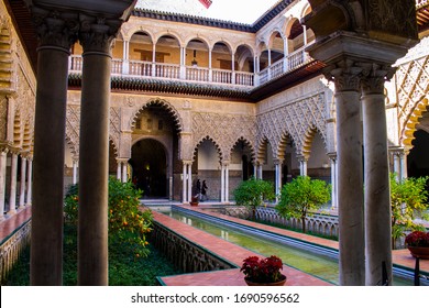 The Magnificent Courtyard (Patio De Las Doncellas) Within The Royal Alcázar Of Seville (Real Alcázar De Sevilla), The Iconic And Famous Moorish Royal Palace. Seville, Andalusia, Spain.