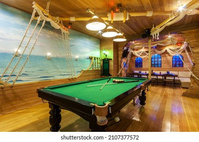 The magnificent design of the billiard room in the style of the cabin company of an old frigate.