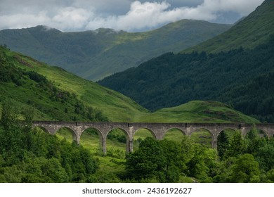 Magnificent Glenfinnan Viaduct set in the stunning scenery of Scottish Highlands, one of most beautiful parts of West Highland Railway. Famous stone railway viaducts among lush and vibrant greenery. - Powered by Shutterstock