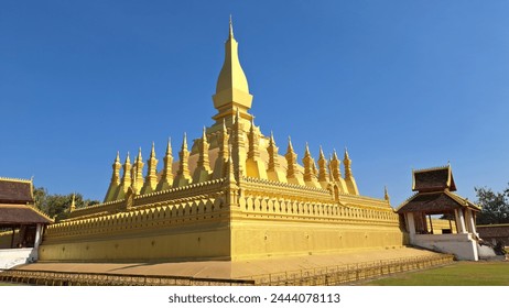A magnificent golden pagoda stands tall against a vibrant blue sky, showcasing intricate traditional Buddhist architecture.
 - Powered by Shutterstock