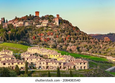 The Magnificent Italian Province Of Tuscany. Evening Twilight. The Winding Road To The Farm. Small Town On Top Of A Hill At Sunset