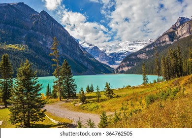 Magnificent Lake Louise is surrounded by mountain peaks and glaciers. Great sunny day. Rocky Mountains, Canada, Banff National Park