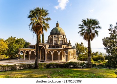 Magnificent monastery surrounded by columns and slender tall palms and cypresses. The Church of the Beatitudes is a Catholic church of the Italian Franciscan convent on the Mount of Beatitudes. 