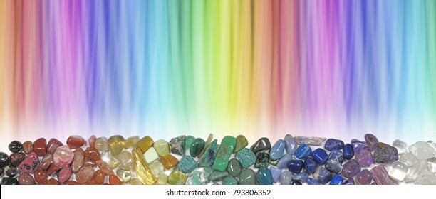Magnificent Multi-coloured Chakra Healing Stones header - wide rainbow coloured graduated banner copy space above with crystal healer's row of chakra coloured tumbled crystal selection below 
