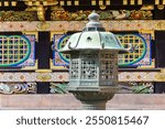 Magnificent stone lantern. Magnificent ornate temple. Japan.The temple and shrine of Nikko Tosho-gu is dedicated to the shogun Tokugawa Ieyasu. Building complex built in 1617. 