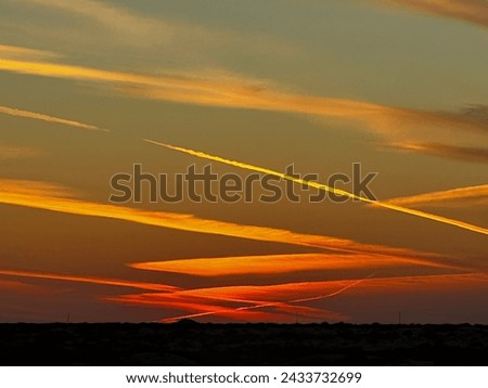 A magnificent sunset sky with scattered cloud and diffracting sunlight.