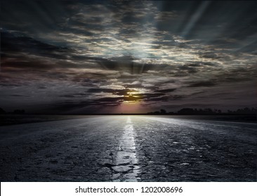 Magnificent view of the asphalt road in the background of the sunset. The road between the fields of wheat and steppe grass. Beautiful sunset on the horizon - Powered by Shutterstock