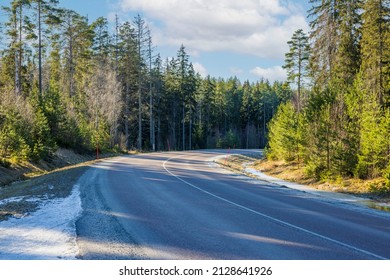 Magnificent View Of Spring Natural Landscape. Forest Asphalt Road With Remains Of Snow. Beautiful Winter Spring Background. Sweden.