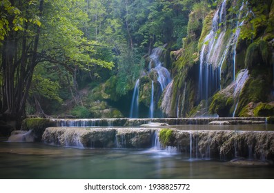 magnificent waterfall called "cascade of tuffs" in the Jura in France in the middle of a forest. This waterfall is a protected natural site. - Powered by Shutterstock