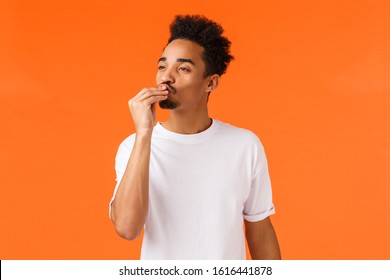 Magnifico. Impressed and delighted african-american guy with moustache and afro haircut, kissing fingers and giving appreciation, praise delicious food, satisfied, express satisfaction good taste