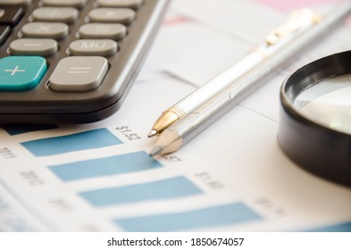 Magnifier calculator lies on a color chart. financial responsibility. High quality photo - Shutterstock ID 1850674057