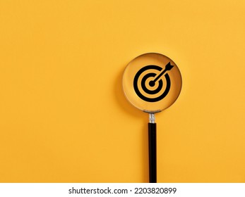 Magnifier focuses on the target icon. Focusing, finding or analyzing business goals and targets concept.
