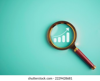 Magnifier glass with bar graph for analysis stock market, Business growth, progress or success concept - Powered by Shutterstock