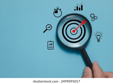 Magnifier glass focus on target dartboard, Business development strategy, and action plan concept with icon business strategy and Action plan, search, goal, strategy, success
