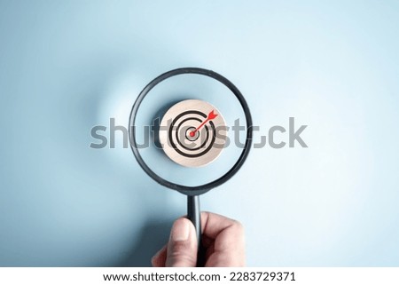 Magnifier glass focus to target icon which for planning development leadership and customer target group concept.