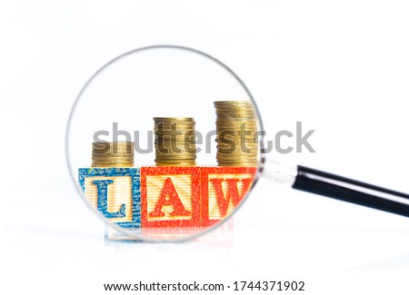 Magnifier glass and money with law concept.