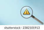 magnifier glass with yellow triangle caution warning sign for notification error and maintenance concept. magnifying glass and with exclamation attention sign. Root cause analysis or solving problem