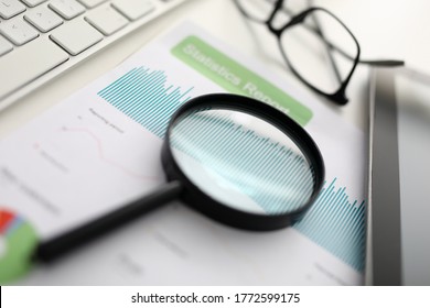 Magnifier glasses lie on table with documents in office. Development and support of small and medium business concept - Shutterstock ID 1772599175