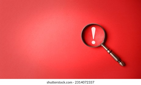 Magnifier magnifying exclamation mark on red background. Alert and precaution concept. Caution and risk management security signal announcement hazard and dangerous notice symbol