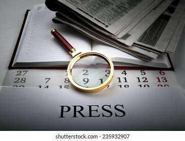 Magnifier and sign the press close up - Shutterstock ID 235932907