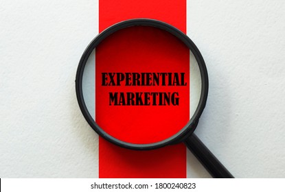 magnifier with text Experiential Marketing on the white and red background