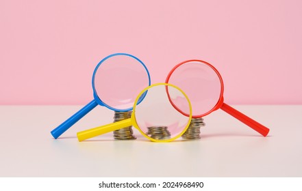 Magnifier And White Coins On The Table. Income Growth Concept, High Percentage Of Investment. Search For New Sources Of Income, Subsidy