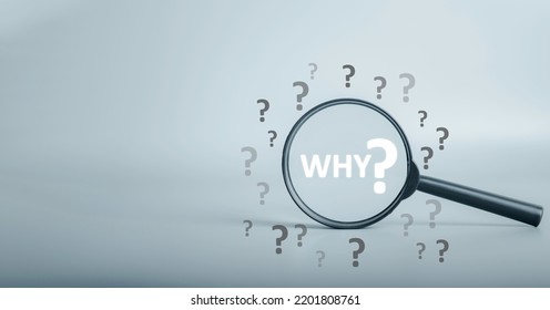 Magnifying focuses on "WHY ?"question text and question mark be around. Business answer and analysis, problem ask, interrogation, research information concept. with copy space on grey background.