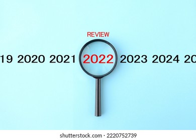 Magnifying glass and 2022 with REVIEW word - Shutterstock ID 2220752739