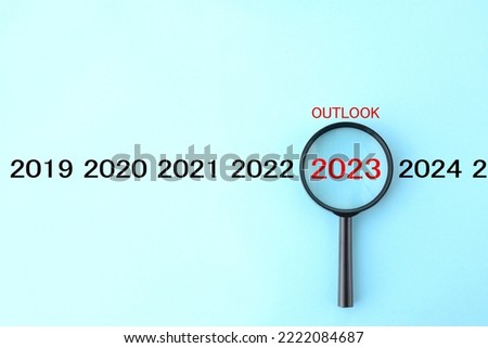 Magnifying glass and 2023 with OUTLOOK word