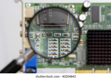 magnifying glass above a circuit board