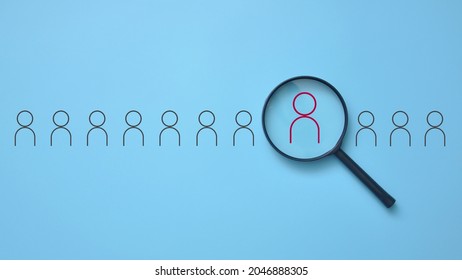 A magnifying glass aimed at the drawing of a person. A symbol of finding a good job candidate. The employer is looking for an employee - Shutterstock ID 2046888305