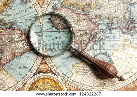 Magnifying glass and ancient old map