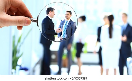 Magnifying glass and businessman in focus