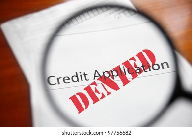 Magnifying Glass And A Denied Credit Application Form