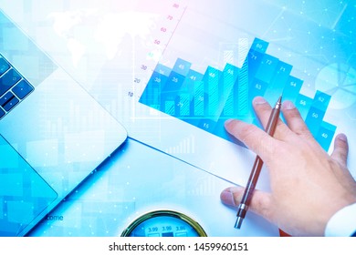 Magnifying glass and documents with analytics data lying on table, business finance background 
