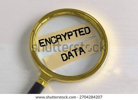 Magnifying glass with encrypted data words on paper pieces