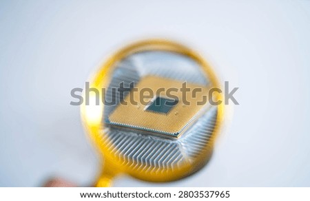 Magnifying glass examining computer processor on CPU cooler, highlighting semiconductor chip, hardware inspection and microelectronics. Concept of artificial intelligence, quality assurance and digital innovation.