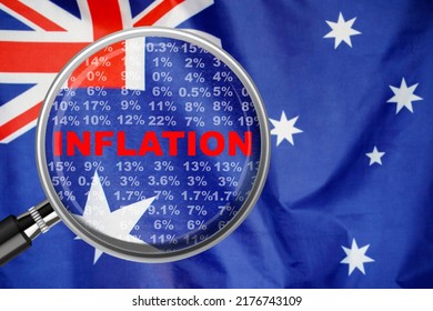 Magnifying Glass Focused On The Word Inflation On Australia Flag Background. Hike Interest Rate. Inflation Income Crisis. Inflation, Tax, Cash Flow And Another Financial Concept In Australia