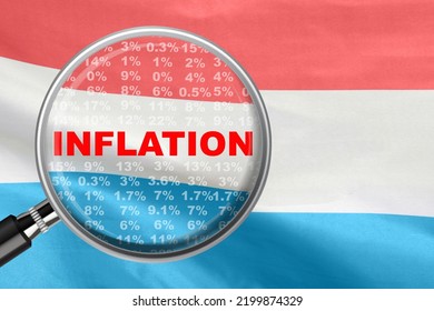 Magnifying Glass Focused On The Word Inflation On Luxembourg Flag Background. Hike Interest Rate. Inflation Income Crisis. Inflation, Tax, Cash Flow And Another Financial Concept In Luxembourg
