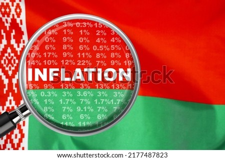 Magnifying glass focused on the word inflation on Belarus flag background. Hike interest rate. Inflation income crisis. Inflation, tax, cash flow and another financial concept in Belarus