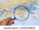 a magnifying glass focusing on India, making the country’s details stand out vividly. The surrounding regions on the map are intentionally blurred to emphasize the central focus.