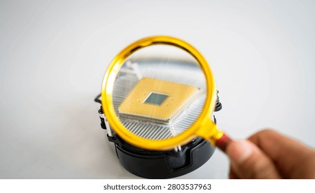 Magnifying glass inspecting computer processor on CPU cooler, highlighting semiconductor technology, hardware analysis and microelectronics. Concept of artificial intelligence, quality control and digital innovation.
