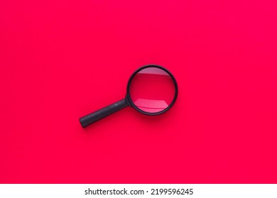 Magnifying Glass Isolated On Red Background