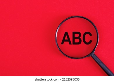 Magnifying glass with letters ABC on red background, Business concept, ABC - short for always be closing - Shutterstock ID 2152595035