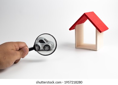 A Magnifying Glass Magnify Car And Little Wooden House Made Of Toy Block. Real Estate Concept, Choose Your Best Deal, Buying One Of This Houses ,House Searching Concept