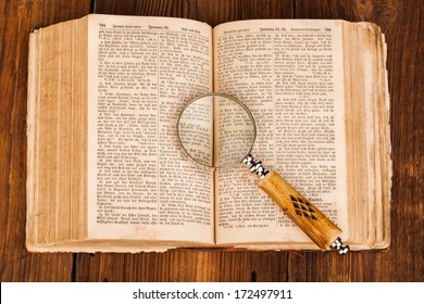 Magnifying Glass And Old Book