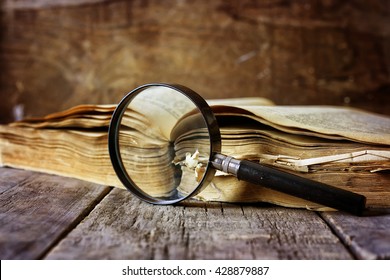 Magnifying Glass And Old Book