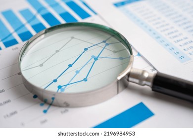 Magnifying glass on chart graph spreadsheet paper. Financial development, Banking Account, Statistics, economy, Stock exchange trading, Business office company meeting concept. - Powered by Shutterstock