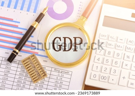 The magnifying glass on the chart is printed with the letter GDP [[stock_photo]] © 