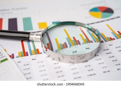 Magnifying glass on charts graphs paper. Financial development, Banking Account, Statistics, Investment Analytic research data economy, Stock exchange trading, Business office company meeting concept. - Shutterstock ID 1904068345